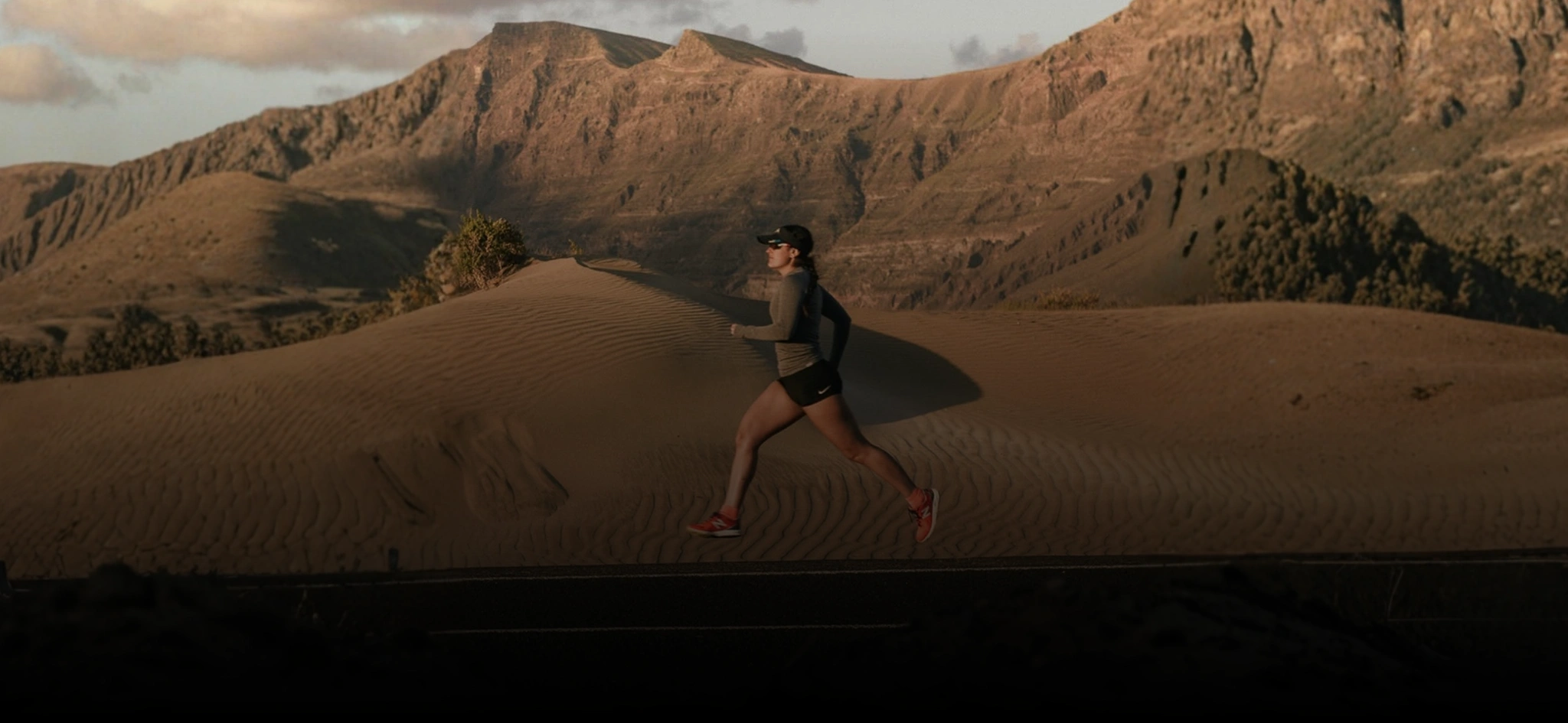 Athlete running on a volcanic road in Lanzarote during a fitness travel holiday in 2026