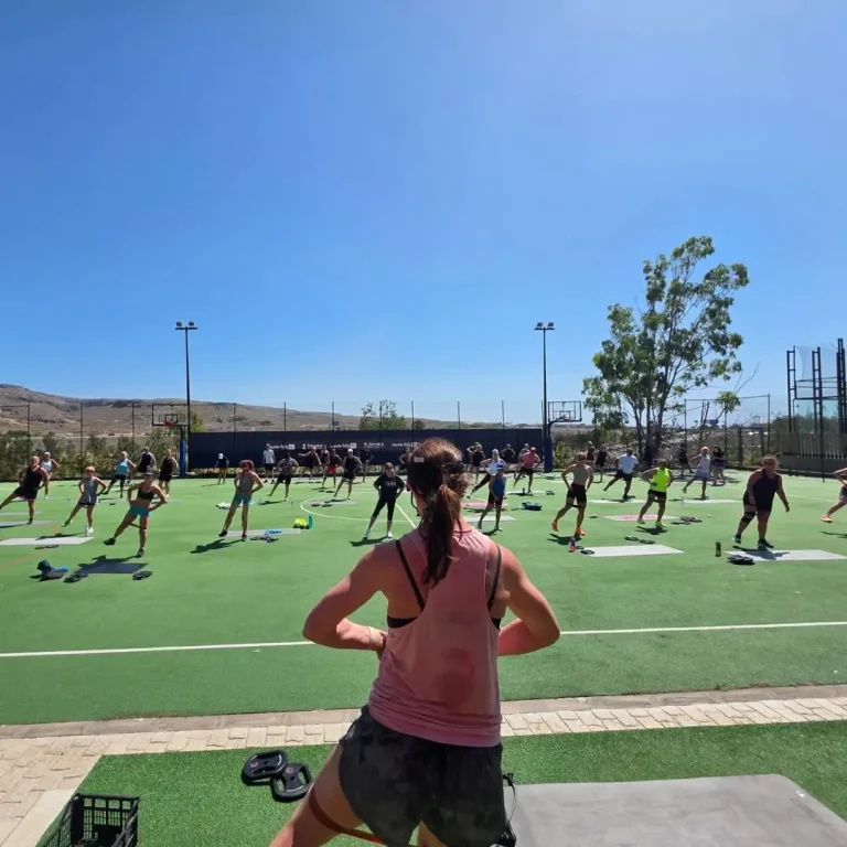 David Muir coaching outdoor fitness exercises during a wellness retreat in Gran Canaria.